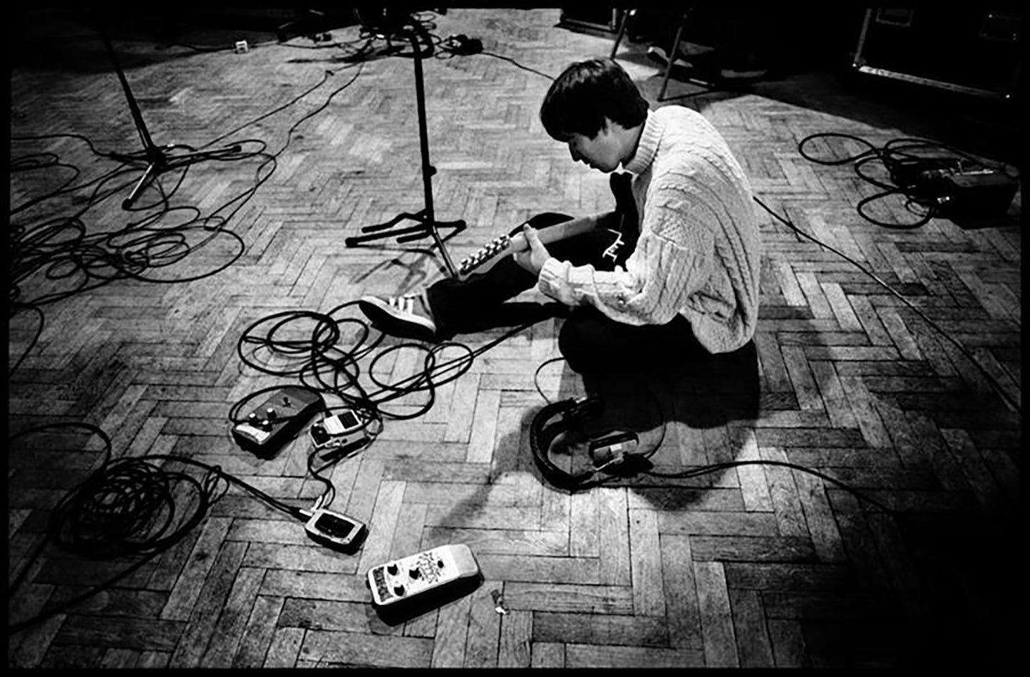 Oasis, Noel Gallagher tuning his guitar at Abbey Road Studios, 1996 by Jill Furmanovsky