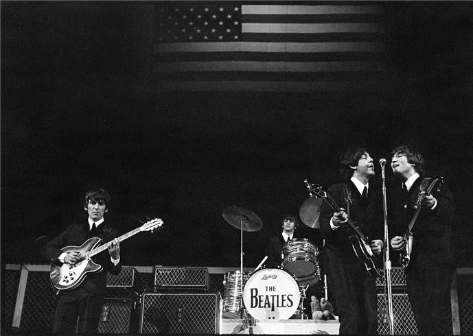 The Beatles onstage with flag, 1964 by Curt Gunther